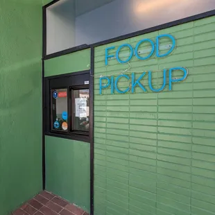 Outside of the building. Scan the QR code to pick up.