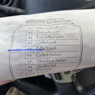 a hand holding a receipt