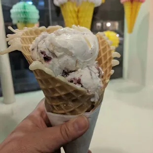 Blueberry Cheesecake icecream in a freshly made waffle cone