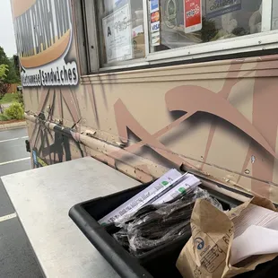 a trash can and a paper bag