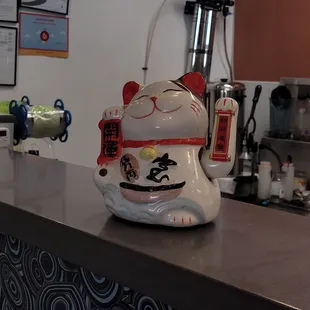 a cat teapot on a counter