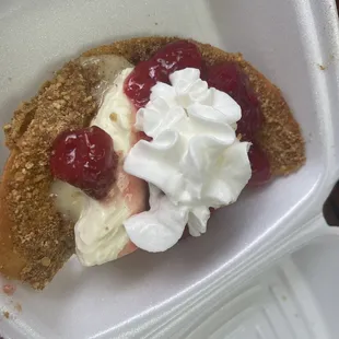 cheesecake tacos with strawberry topping. and whip cream