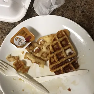 a plate of waffles and a cup of coffee