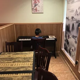 a young boy playing the piano