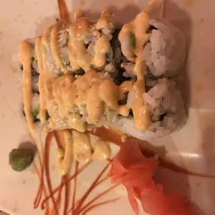 a plate of sushi with sauce