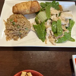 Chicken and snap peas lunch portion with fried rice and egg roll