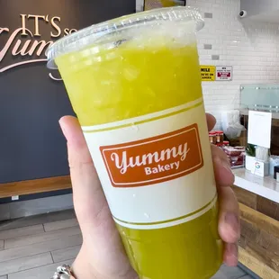 a person holding a cup of juice