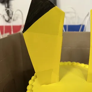 a yellow cake with black icing