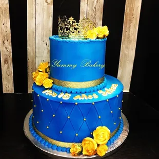a blue cake with yellow roses