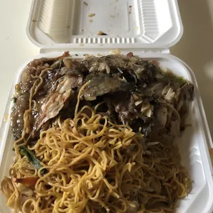 a container of noodles and meat
