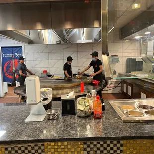 two men preparing food in a restaurant kitchen