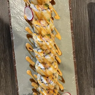 a plate of sushi with sauce