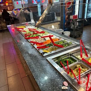 a variety of salads in a buffet