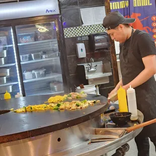 a man preparing food in a commercial kitchen