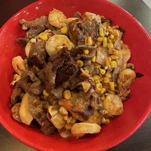 a red bowl of food on a table