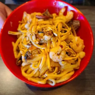 a person holding a bowl of food