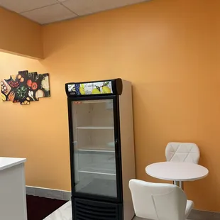 a refrigerator and table in a room