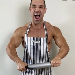 a shirtless man holding a knife