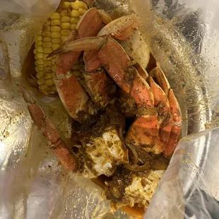 cooked crab legs and corn on the cob