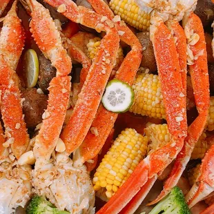 crab legs, corn, and broccoli