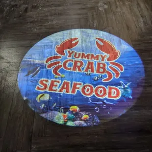 Yummy Crab logo projected onto the floor