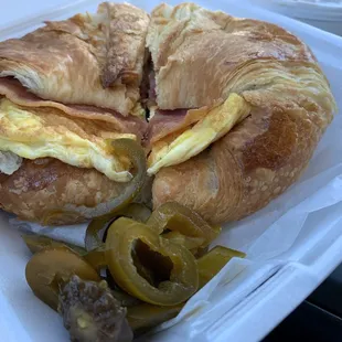 Ham Bacon and egg croissant with a side of jalapeños