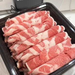 raw meat in a plastic container