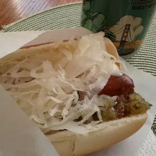 a hot dog with sauerkraut and onions