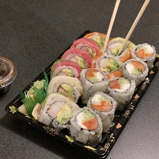 a plate of sushi with chopsticks