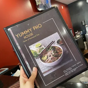 a person holding a menu