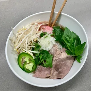 House Yummy Pho Large   Comes with rare beef, cooked brisket, meatballs and tripe $15