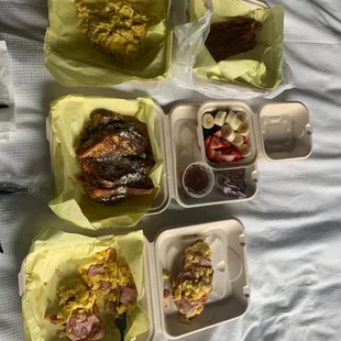 Eggs on croissant with ham &amp; cheese and French toast with side of eggs &amp; bacon.
