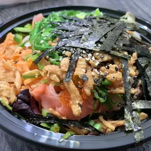 a bowl of sushi and vegetables