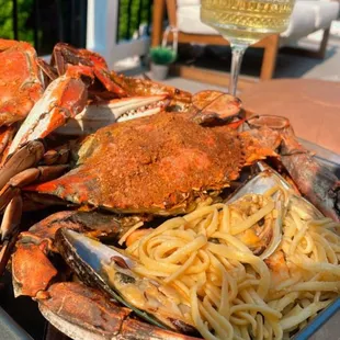 a tray of noodles and crabs