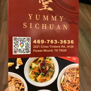 a hand holding a restaurant menu