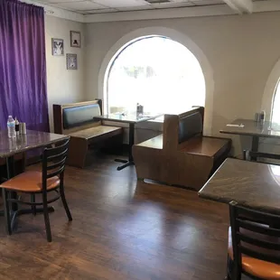a dining area with tables and chairs