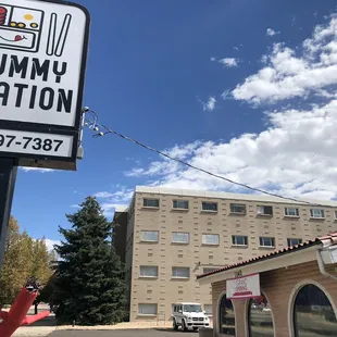 yummy station sign in front of a building