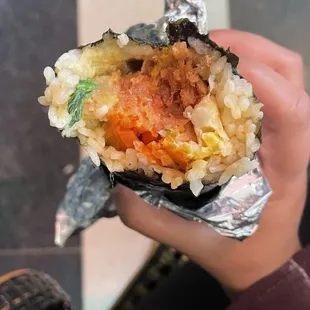 a person holding a piece of food