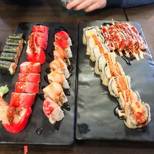 two plates of different types of sushi