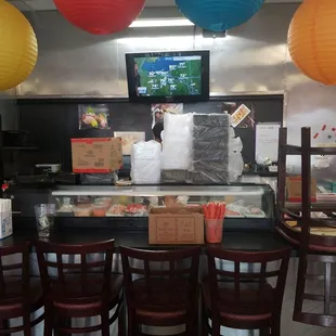 a restaurant with a counter and chairs