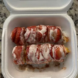 Fruit roll with pineapple inside and strawberry soy paper and strawberries and love sauce