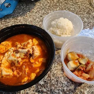 Korean soft tofu stew with kimchi, rice, and sides. Love it!