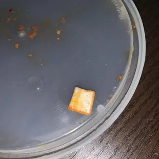 a dirty plate with a piece of food in it