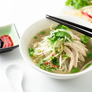 a bowl of soup and chopsticks