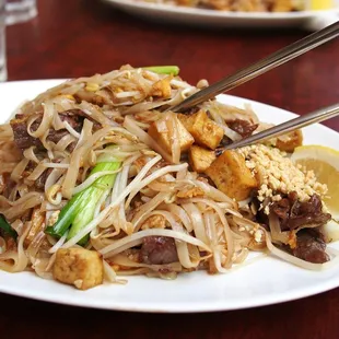 a plate of food with chopsticks