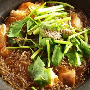 a bowl of noodles with meat and vegetables
