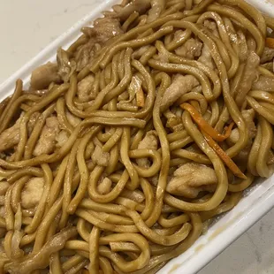 a white container filled with noodles and meat