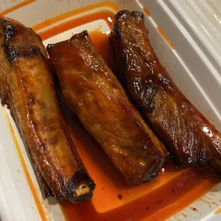 three pieces of meat in a dish