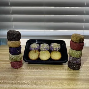 a plate of donuts and a tray of donuts