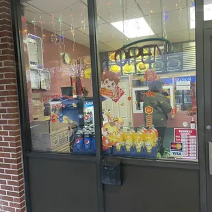 a storefront window with a candy shop sign